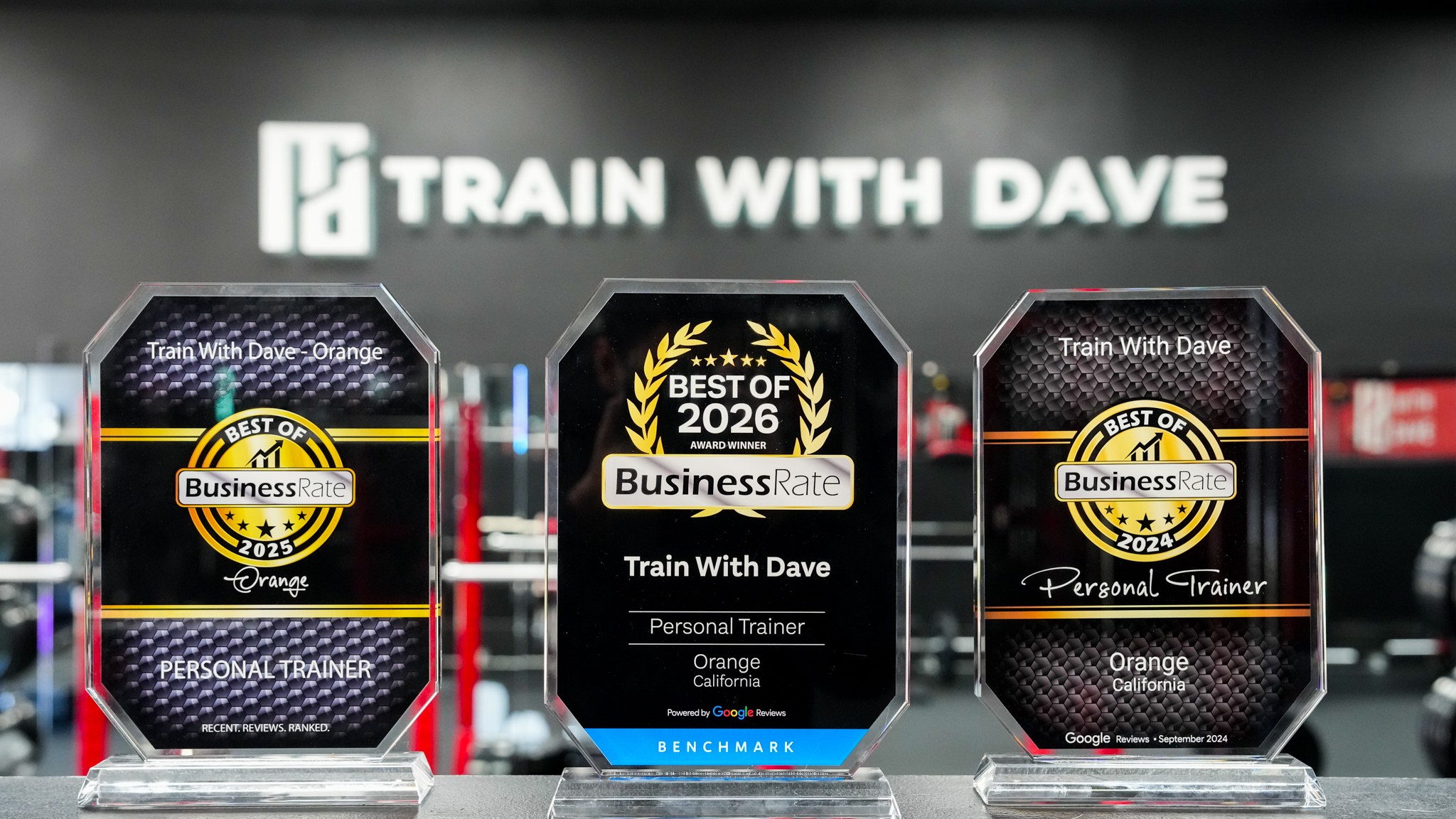 Three Train With Dave Orange award plaques on display — Business Rate Best Personal Training in Orange 2024, 2025, and 2026